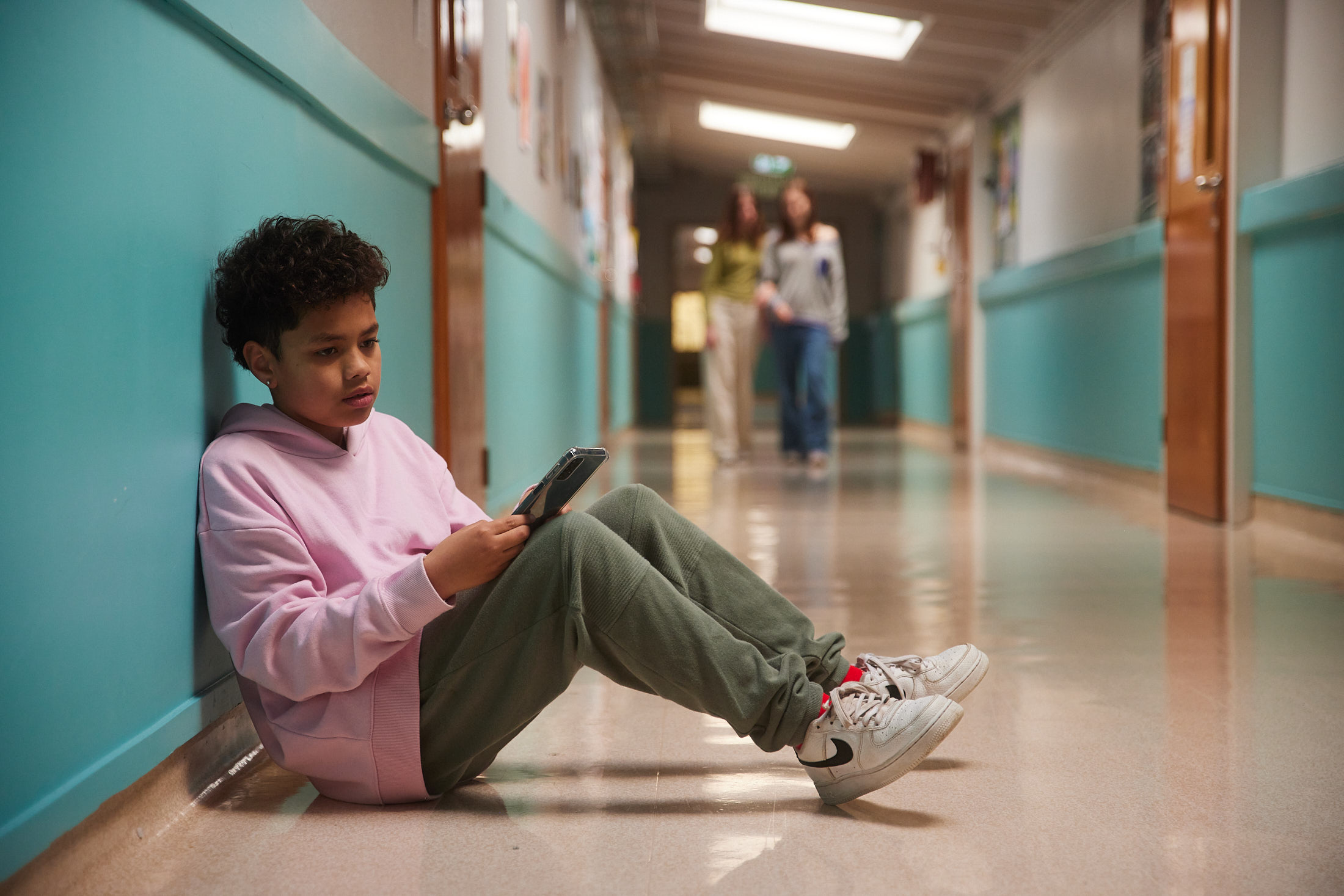 child sitting in a corridor